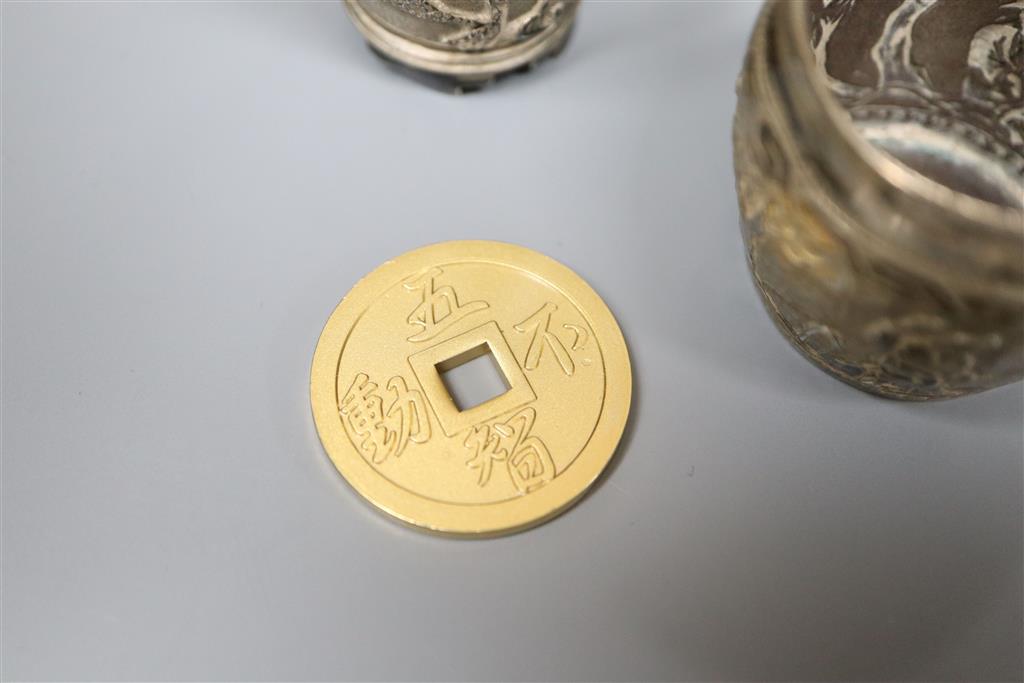 A pair of Chinese white metal pepperettes, 7cm, a similar salt, small goblet and a coin.